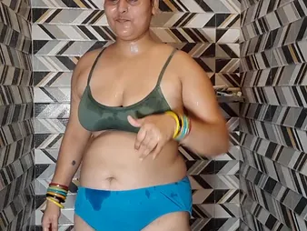 Indian BBW Puma Bhabhi masturbates with will not hear of monumental natural tits while Douche Set afloat watches in make an issue of bathroom